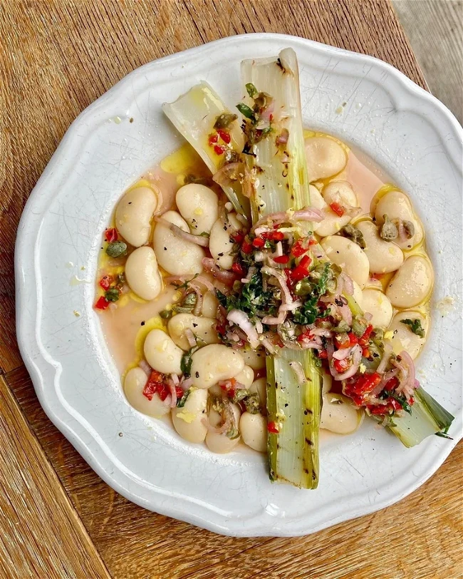 Image of Creamy Butter Beans with Griddled Leeks and Caper + Mint Salsa