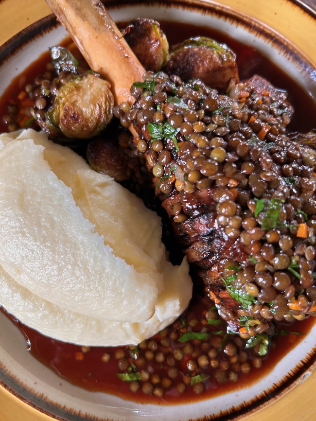 Image of braised lamb shanks with green lentils, roasted brussels sprouts & olive oil mash potatoes