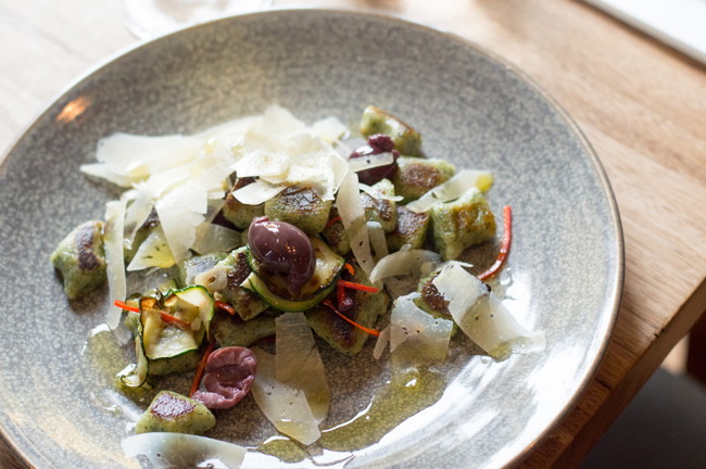 Image of fresh nettle gnocchi with olives, zucchini & chilli