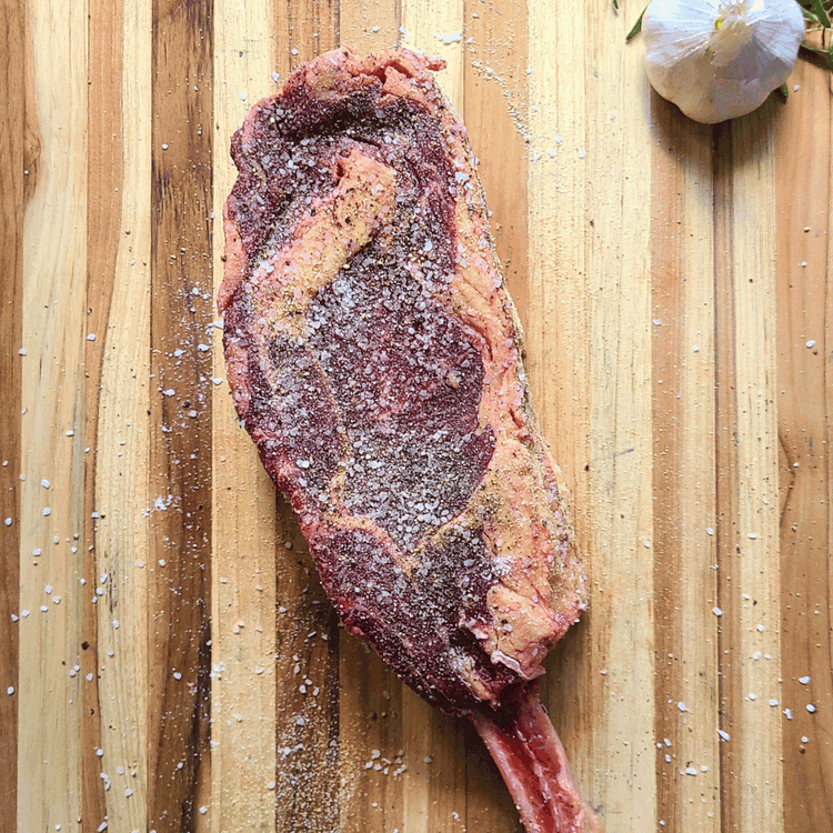 Image of In a small bowl, mix together the kosher salt, freshly ground black pepper, and garlic powder.. Generously apply the salt, pepper, and garlic mixture to the steak, ensuring it is evenly coated on all sides.