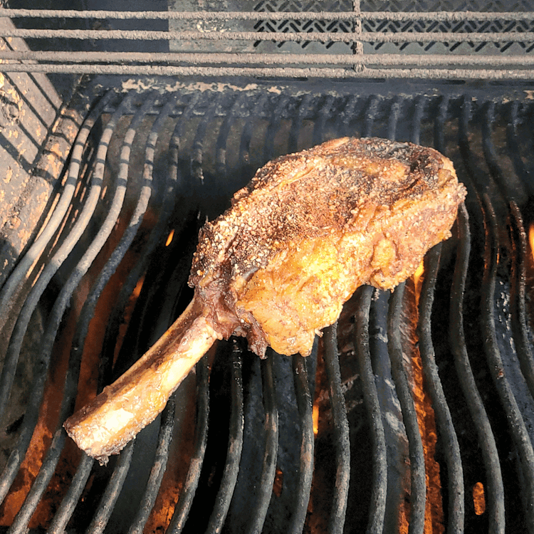 Image of Place the steak on the preheated BBQ grill. Sear the steak for a few minutes on each side until a deep brown crust forms. Be sure to sear the edges as well.