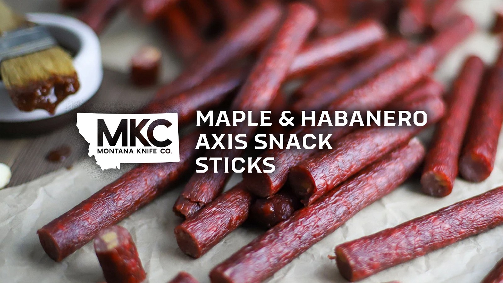 Venison meat sticks are sitting on a table with the overlay “Maple & Habanero Axis Snack Sticks.”