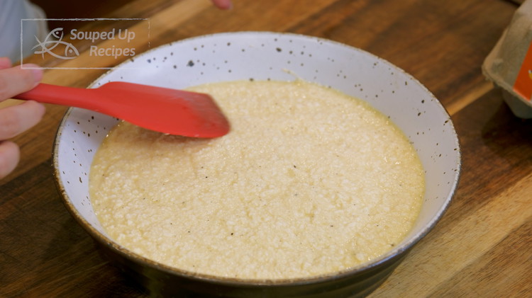 Image of Pour the egg and tofu mixture onto a heat-proof serving plate. Shake and tap a few times to level the mixture.