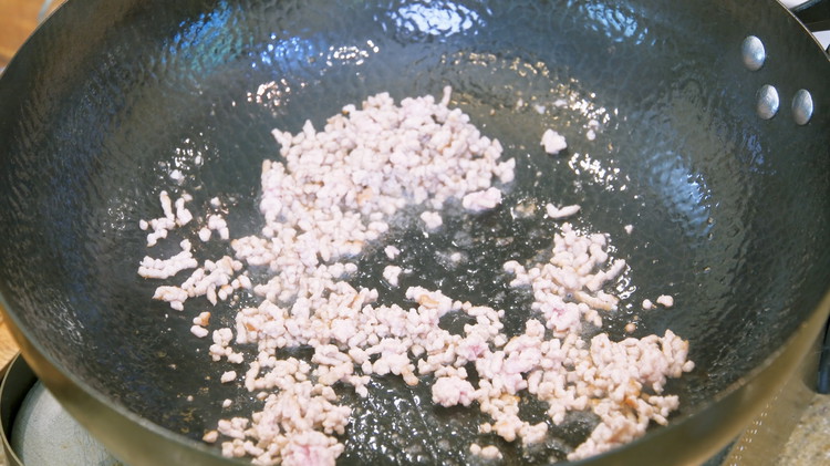 Image of While waiting, we can make the pork gravy. Heat your wok to smoking hot and add a drizzle of oil and some ground pork. Stir until the meat changes color, which only takes a minute or 2. If you don’t eat pork,...