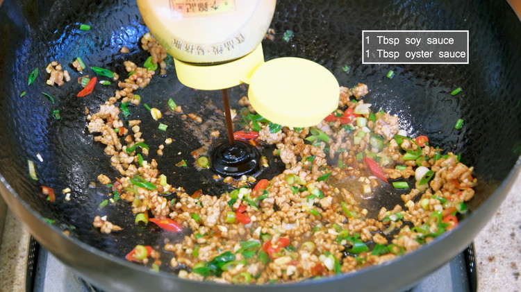 Image of Season the pork with 1 Tbsp of soy sauce and 1 Tbsp of oyster sauce and stir well.