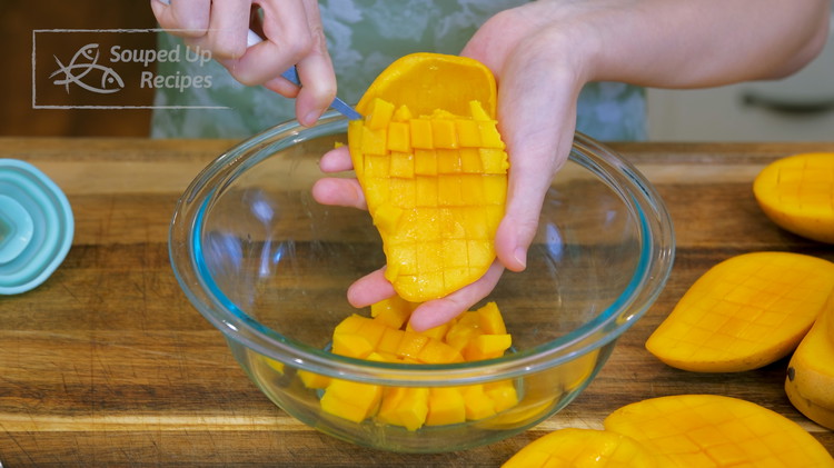 Image of Take a spoon and scoop the mango meat out. Oh, by the way. Make sure the dice are not too big because this is supposed to be a drinkable dessert that you will serve with a thick straw. You want the mango pieces to...