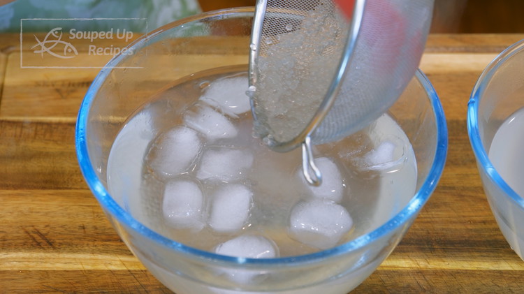Image of By now, the tapioca pearls should be done soaking. You can see that the white center in the tapioca pearls is disappeared. That is perfect. Drain the pearls and transfer them into an ice bath to firm up the texture.