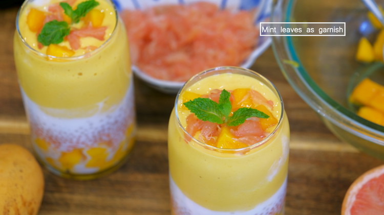 Image of To assemble the dessert, add some diced mango to the bottom of a cup; follow up with a layer of shredded grapefruit and a layer of tapioca pearls; then pour in 1/4 cup of coconut milk and fill the rest of the space with the mango...