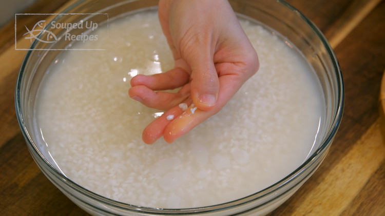 Image of By now, the glutinous rice should be done soaking, check the consistency by crushing the grains in between your fingers. If it is crushable, you are good to go. Drain the rice completely.