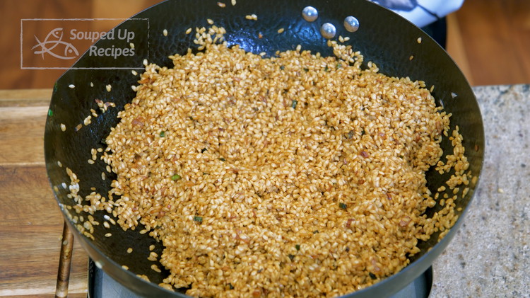 Image of Add the soaked and well-drained glutinous rice and 4 tsps of dark soy sauce to give the rice that desired color. Stir over medium heat for a few minutes or until the grains becomes slightly sticky, so it will be much easier...