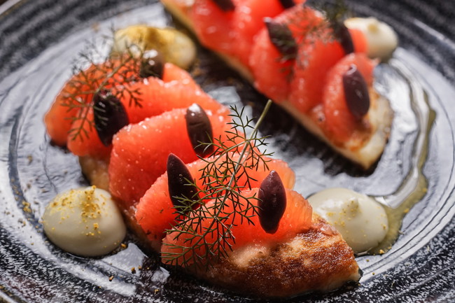 Image of pan-fried halloumi with honey, ruby grapefruit, black olives & fennel purée