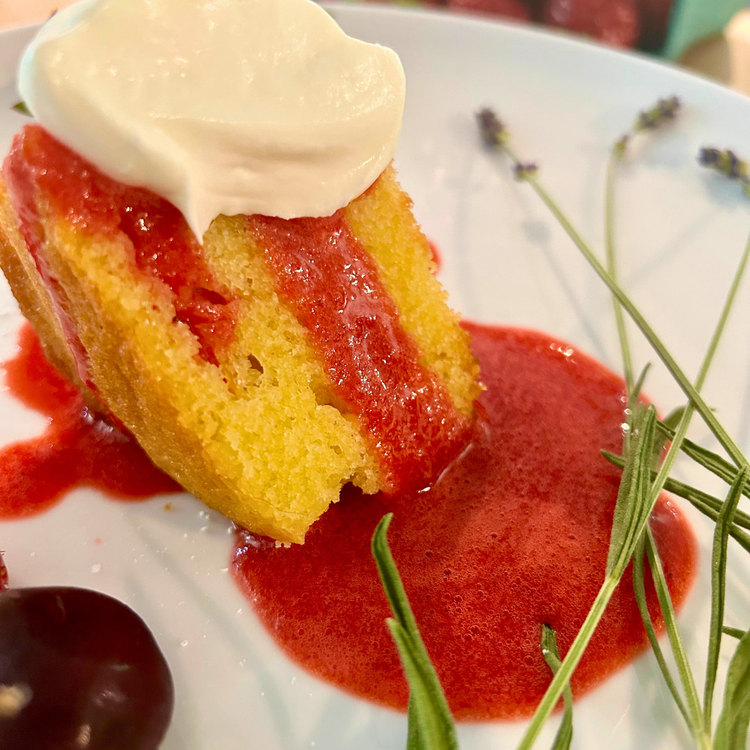 Image of Allow your cake to cool fully before slicing. Top each slice with a generous spoonful of sauce and a dollop of whipped cream. Garnish with fresh lavender and enjoy!