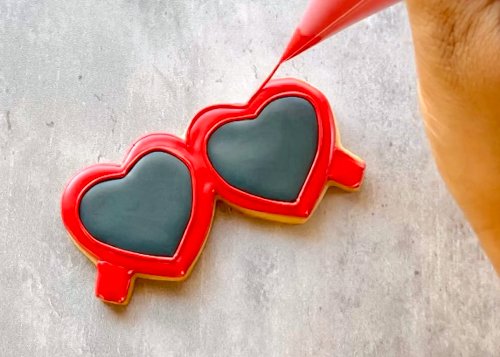 Image of You can leave the glasses as-is, or outline the frames with red outline consistency icing to create more detail and depth to your design.  