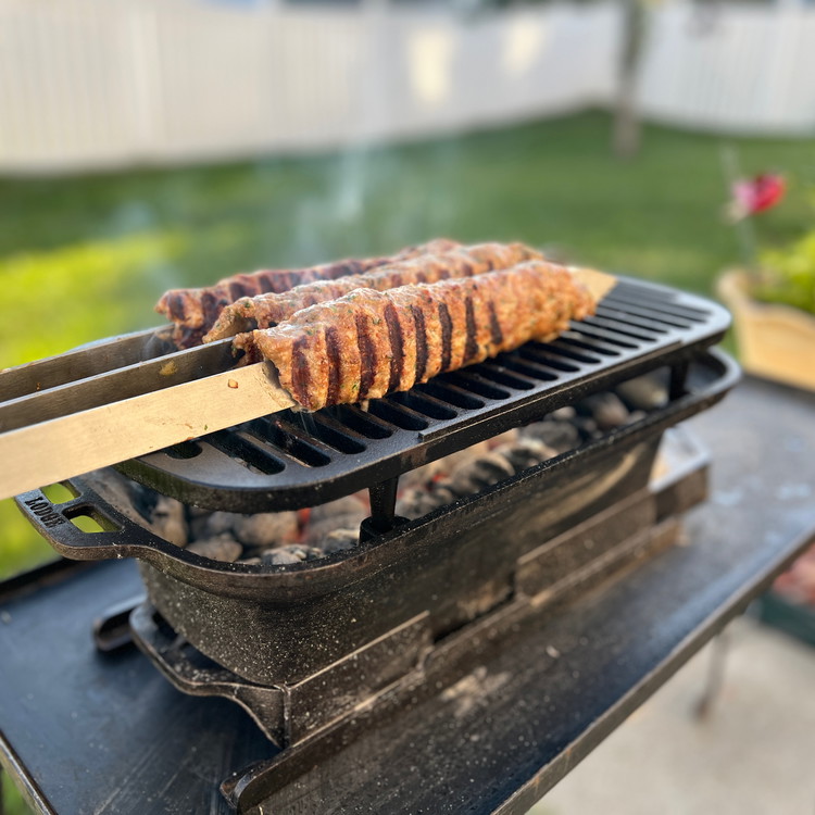 Image of Place the koftas on a hot grill set 5 inches above the coals.