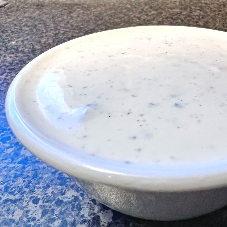 Image of Mix greek yoghurt, mayonnaise, water, vinegar, salt, pepper, parsley, sugar and lemon juice in a bowl and stir well to combine.