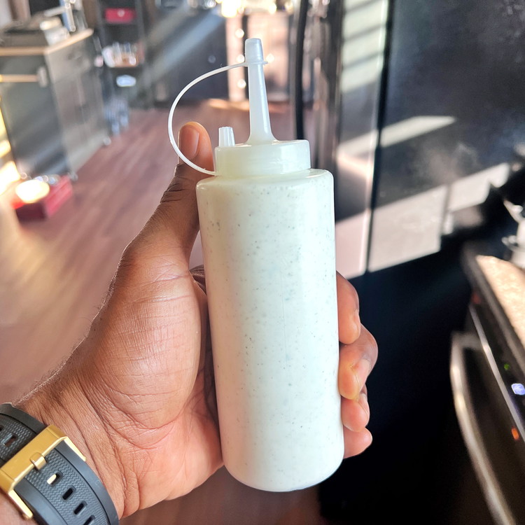 Image of Optional: Fill a plastic condiment bottle with the white sauce. This will make it easier to drizzle the sauce over the dish.
