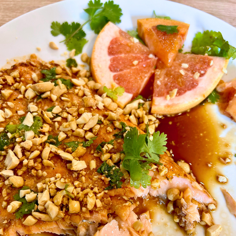 Image of Top finished salmon with a generous amount of crushed peanuts, grapefruit slices, fresh cilantro or basil if desired, and a little extra sauce. Excellent when served with Jasmine rice.