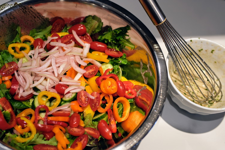 Image of Chop all the vegetables and assemble in a large bowl with greens.  Remove the onions from the vinegar and add to the bowl of salad ingredients. 