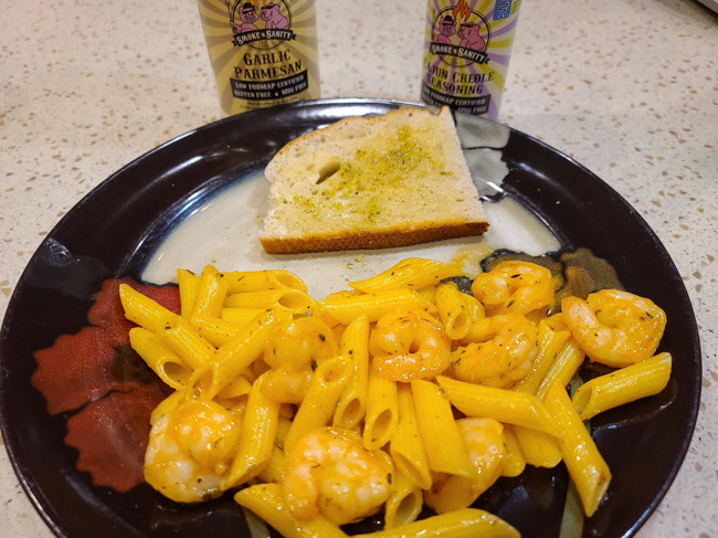 Plate of cajun creole shrimp pasta with a slice of garlic parmesan toast