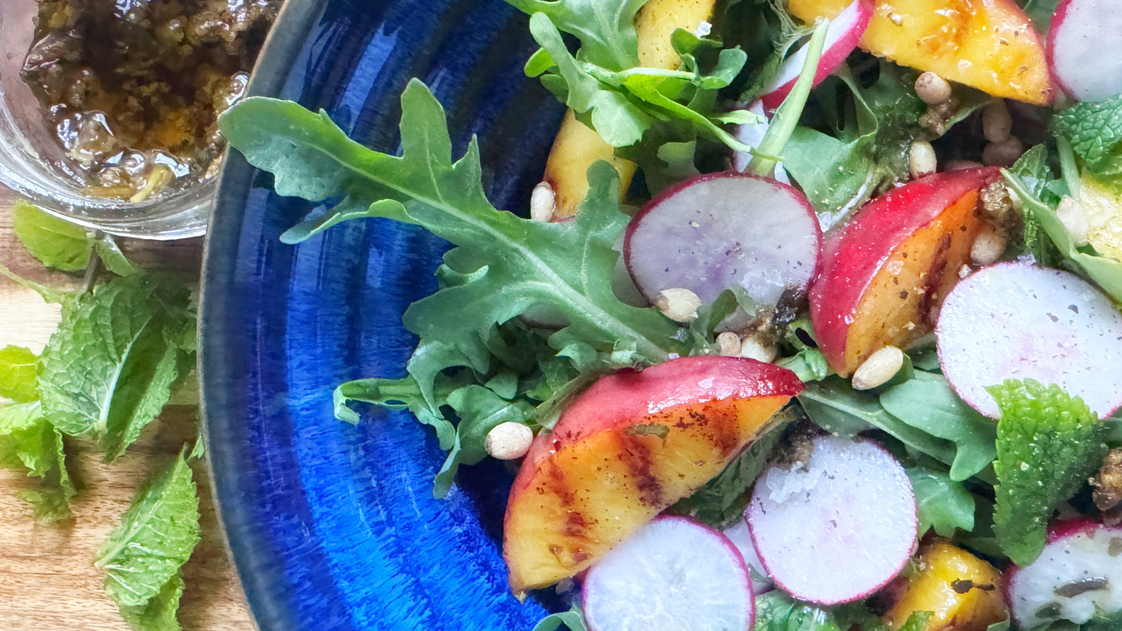 Image of Arugula Salad with Peach, Radish, Mint, and Pesto