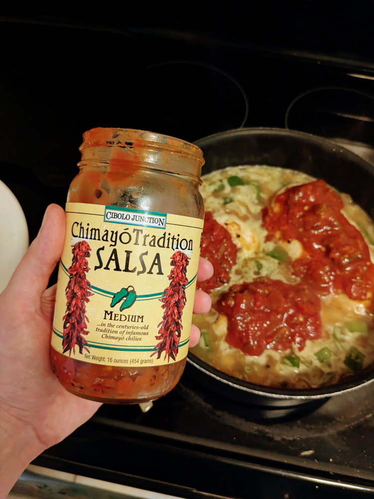 Image of Add chicken stock, rice, and salsa, stirring to combine.