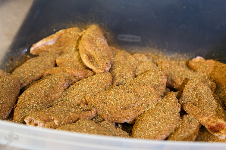 Image of Add wings to a large bowl or container and add oil and stir to coat the wings and sprinkle on the Jerk Seasoning liberally. 