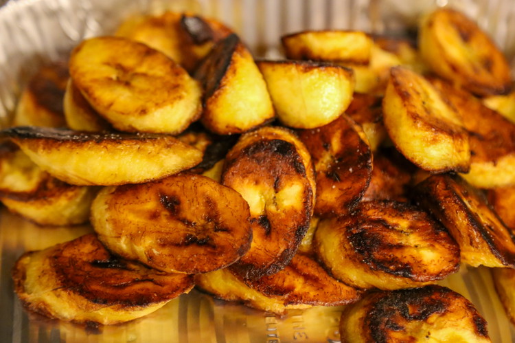 Image of Add the plantains to the pan and add a pinch or two of salt to the tops of the plantains in the pan. Fry them, adding more coconut oil as needed to keep them bubbling. Flip and remove when they...