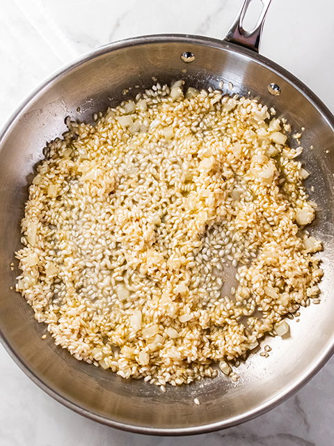 Image of Add arborio rice to skillet and stir to coat. Cook...