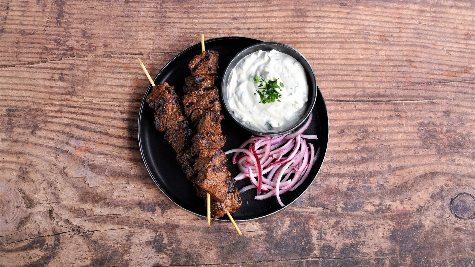 Image of Spiced Beef Kebabs with Yogurt-Tahini Sauce and Pickled Onions