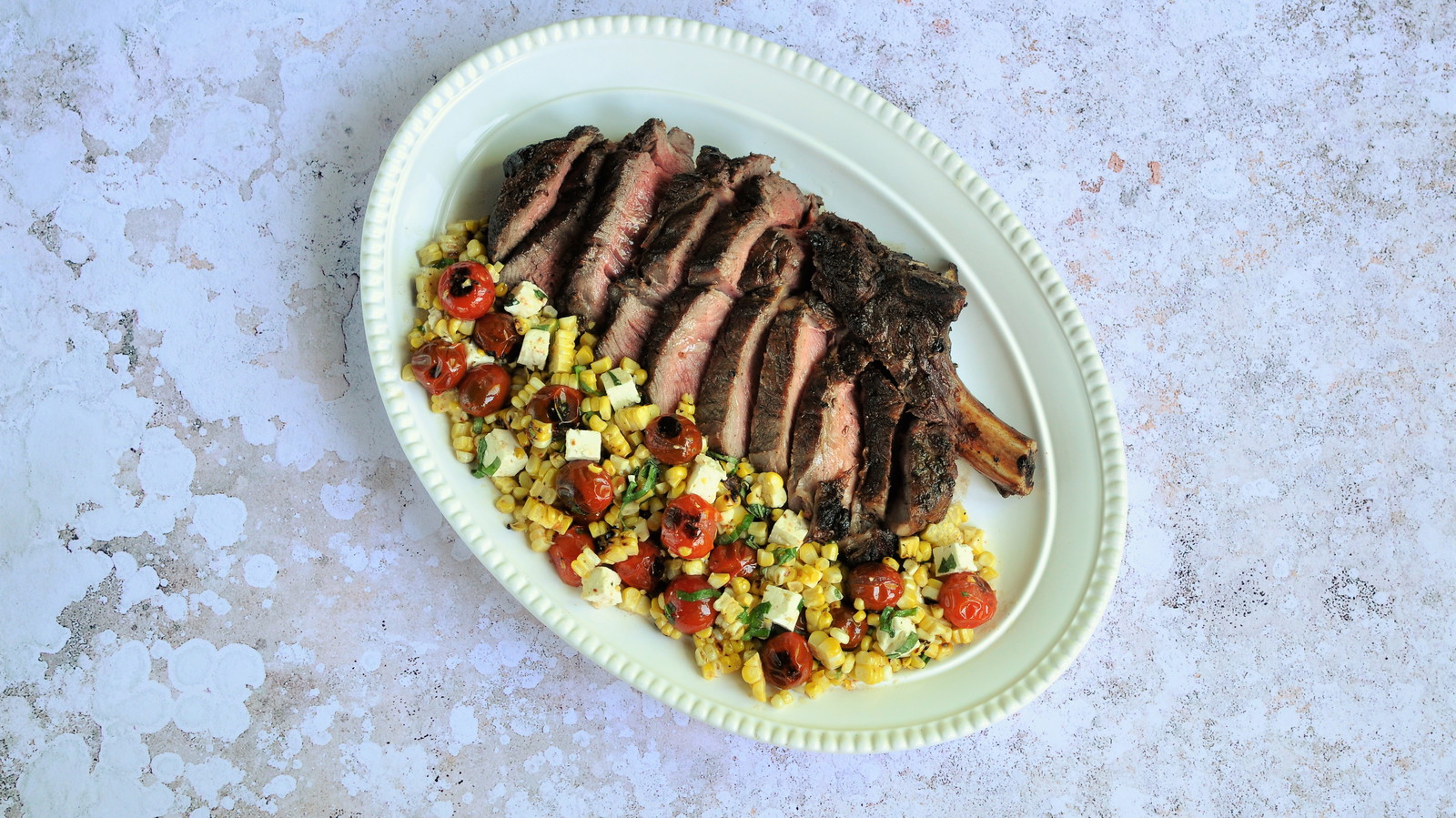 Image of Grilled Cowboy Steak with Blistered Corn and Cherry Tomato Salad