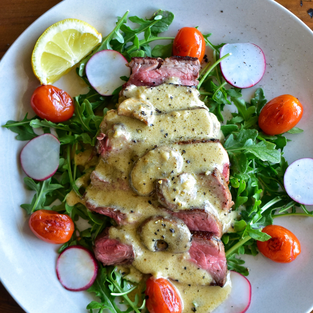 Seared Top Sirloin Over Baby Arugula with Warm Creamy Peppercorn & Portobello Sauce