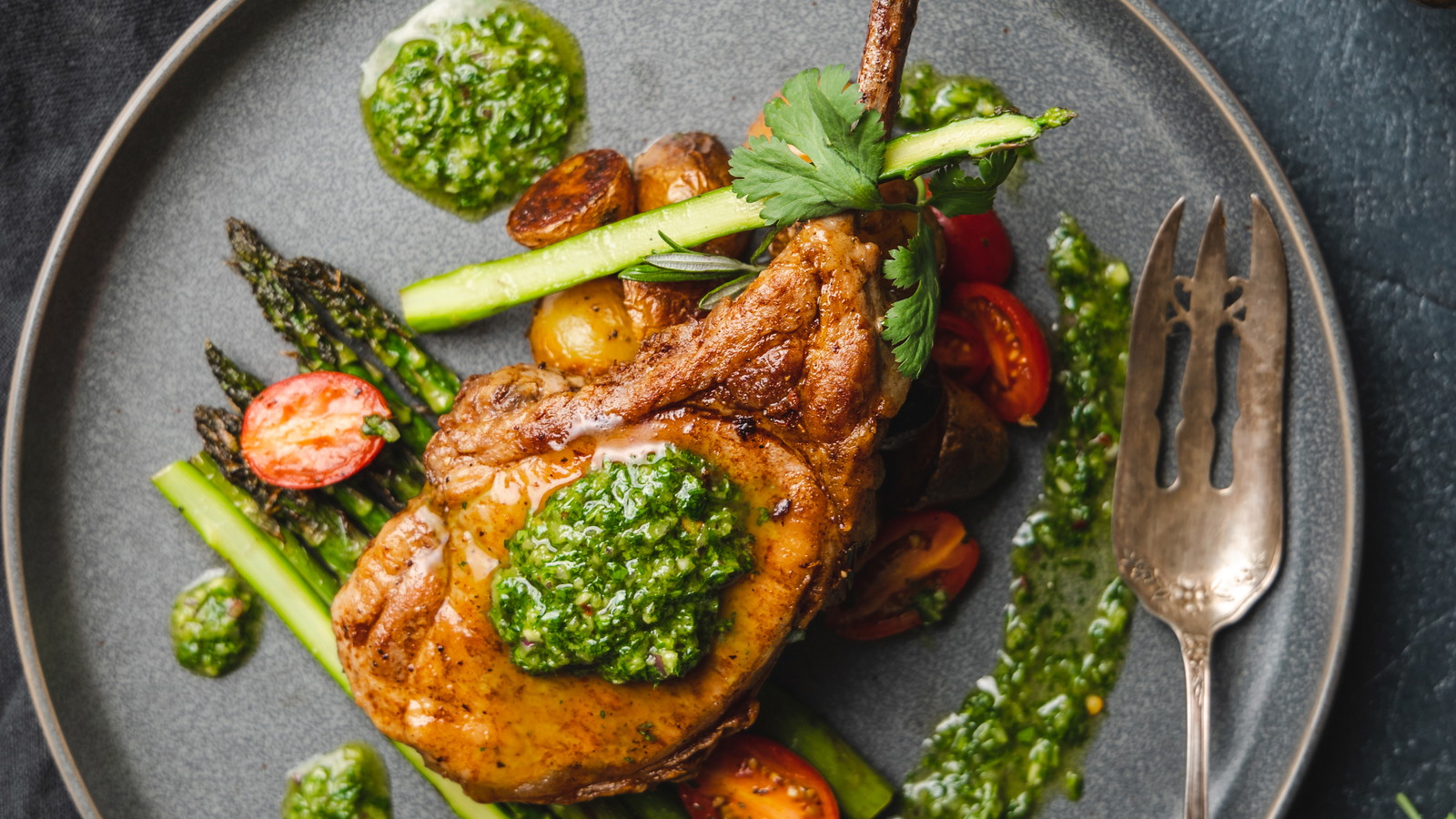 Image of Rosemary Pork Chop with Chimichurri, Roasted Baby Potatoes and Asparagus