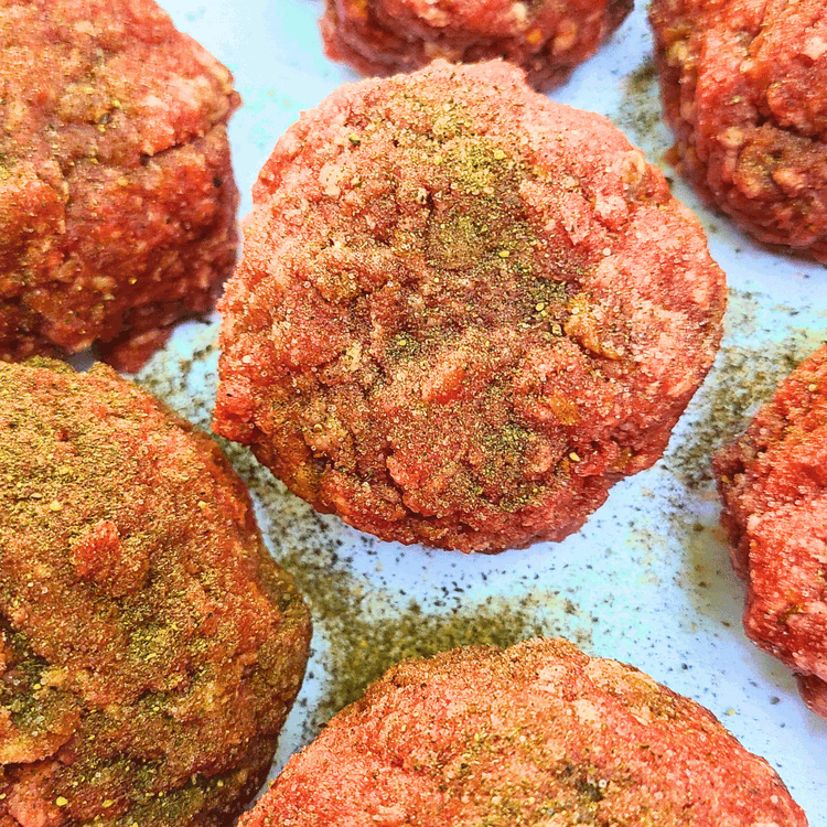 Image of Divide the seasoned elk meat into 4 equal portions and form them into balls. (if you are using more than one pound of meat to feed a crowd, aim for about a ¼ lb per patty) season again with more...