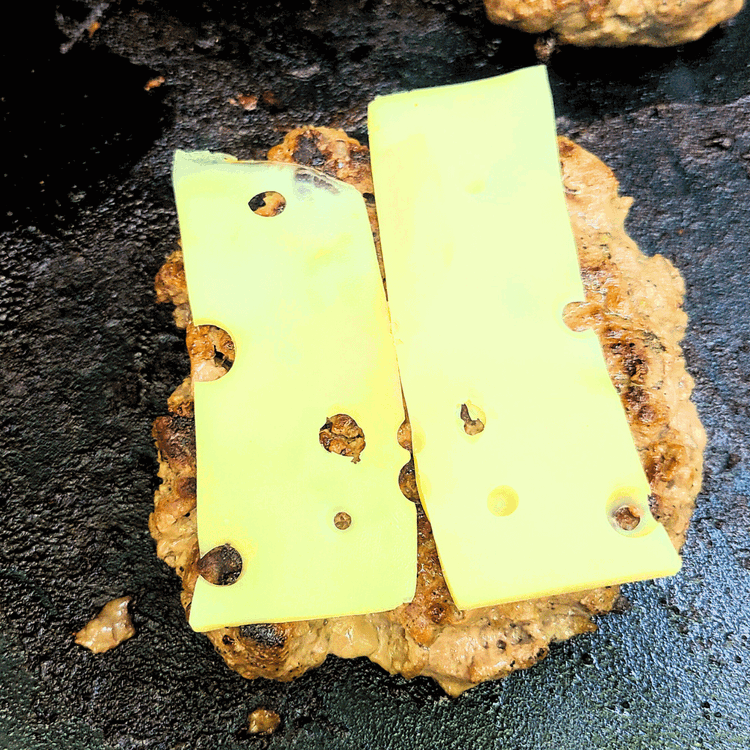 Image of Place a slice of cheese on each patty during the last minute of cooking and allow it to melt.