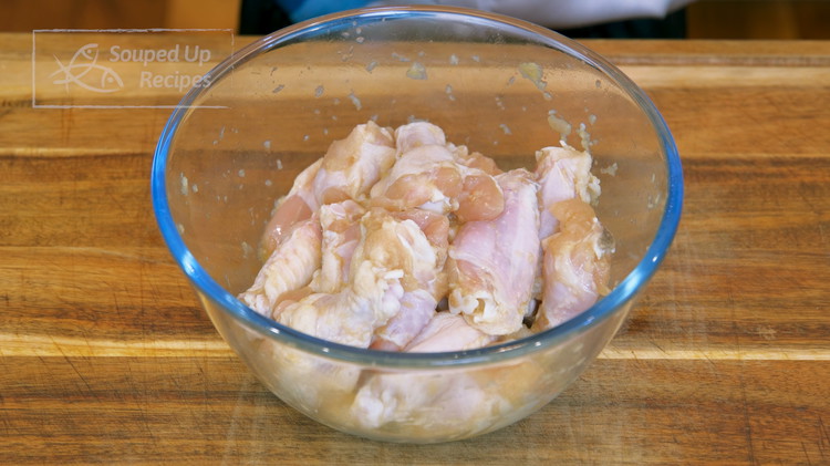 Image of Use paper towels to dry chicken wings. Marinate the wings with 1 tsp of sugar, 1 tsp of salt, 1 tbsp of soy sauce, 1 tbsp of Chinese cooking wine, 1/2 inch of ginger (grated), and 4 cloves of garlic (grated). Mix...