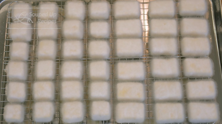 Image of 36 hours later, all the tofu is covered completely with white mycelium. I know it looks like mould. In fact, it is a non-harmful and edible mould, which gives the tofu that unique taste.
