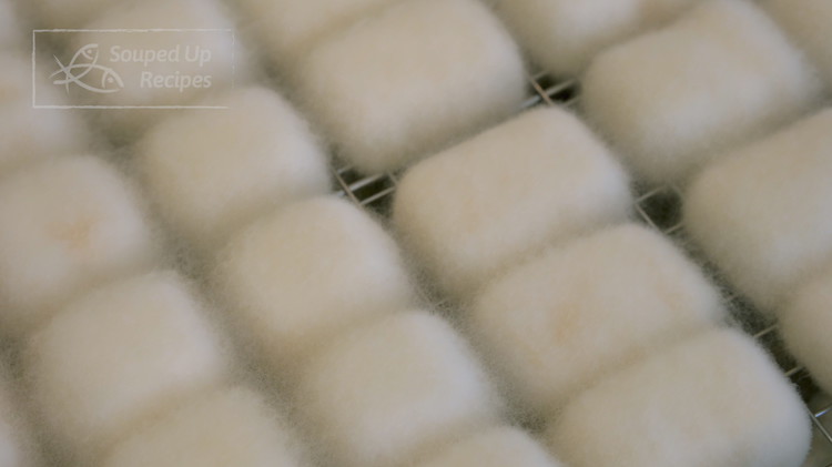 Image of in 60 hours, all the tofu became fluffier because the mycelium grew much longer, and started connecting the tofu cubes next to it. They look like cotton cubes. That is when you know it is done.