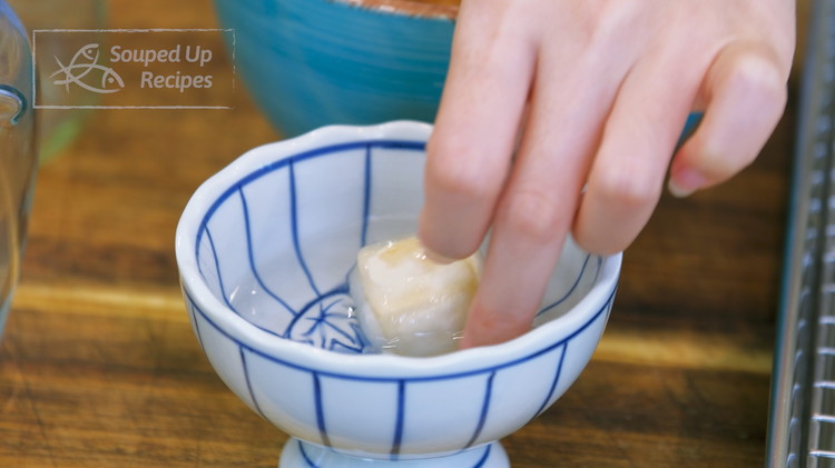 Image of Take a piece of tofu and dip it in the vodka. Flip to wet all the sides. The fluffy mycelium terns to absorb a lot of liquid. You should slightly shake off the excess so the tofu is not too...