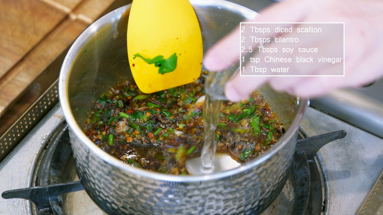 Image of To make a dipping sauce, add 1.5 Tbsp of cooking oil, 1.5 tbsp of minced garlic, and 2 tsp of red chili flake into a saucepan. Stir until fragrant. Continue by adding 2 tbsp diced scallion and 2 Tbsp of...