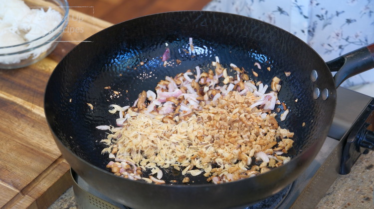 Image of Add the diced shallot, garlic, shiitake mushroom, sundry baby shrimp, and pork lard dregs. Stir for a few minutes or until fragrant.