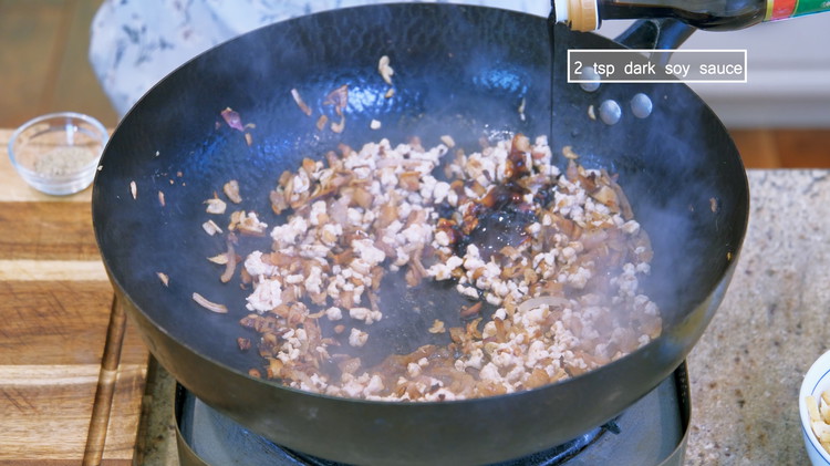 Image of Season the filling with white pepper, soy sauce, oyster sauce, and dark soy sauce, and stir well.