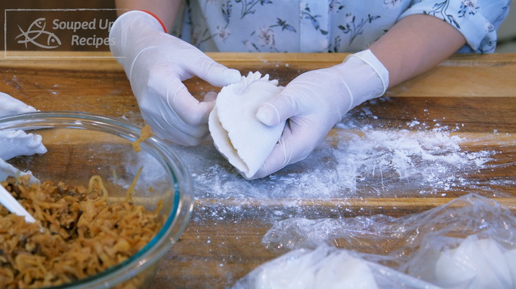 Image of Fold the wrapper in half and pinch the edge to seal the dumpling. Apply that to the rest of the dumplings.
