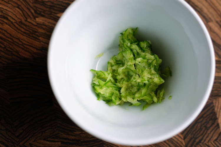 Image of Squeeze out the grated cucumber to remove water content. You can use a strainer or cheesecloth.  The quantity is so small that I just squeeze out the water in my hand.  It is important to remove and discard this excess...