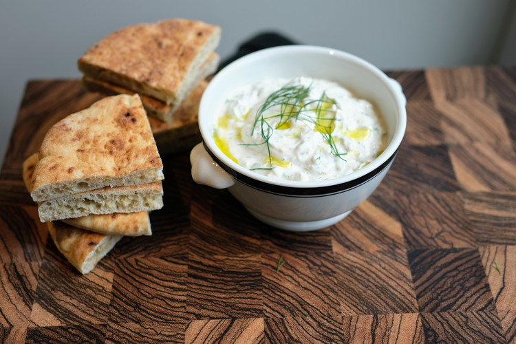 Image of Serve in a bowl drizzled with a little bit of olive oil and alongside some pita bread or vegetable sticks for dipping.