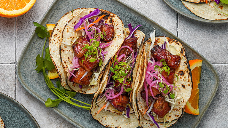 Crispy Smoked Kurobuta Pork Belly Tacos with Serrano-Orange Glaze and Pickled Red Onions