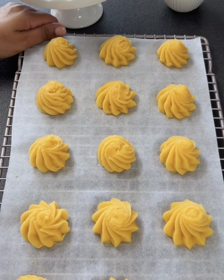 Image of Place the mini cream puffs in the preheated oven. After 20 minutes, reduce the temperature to 180°C (356°F) and bake for an additional 5-8 minutes until golden brown. Important: Do not open the oven door during baking to prevent the...