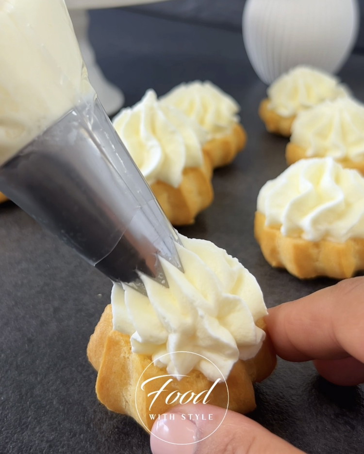 Image of Horizontally cut the cream puffs and fill them with the whipped cream.