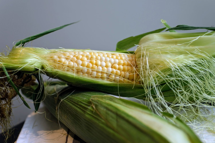 Image of Set large pot of water to boil and shuck your corn. 