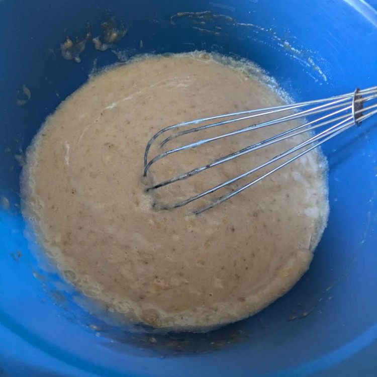 Image of In a mixing bowl, add mashed banana, sweetener, plant milk, and melted coconut oil. Stir to combine.