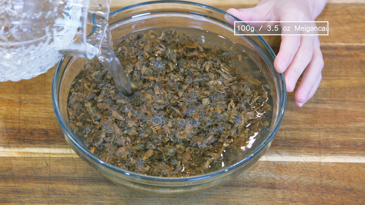Image of Soak the meigancai in clean water for 1 hour. Set it aside while you work on other ingredients. 